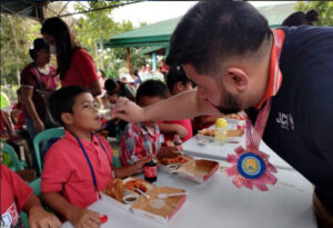 VP Anton wiping food from child's mouth
