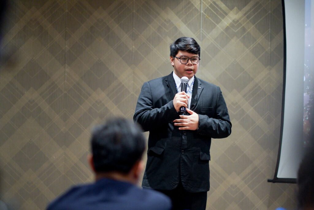 Allyn Jaspher "Jas" Basit giving his all on the Public Speaking Contest stage
