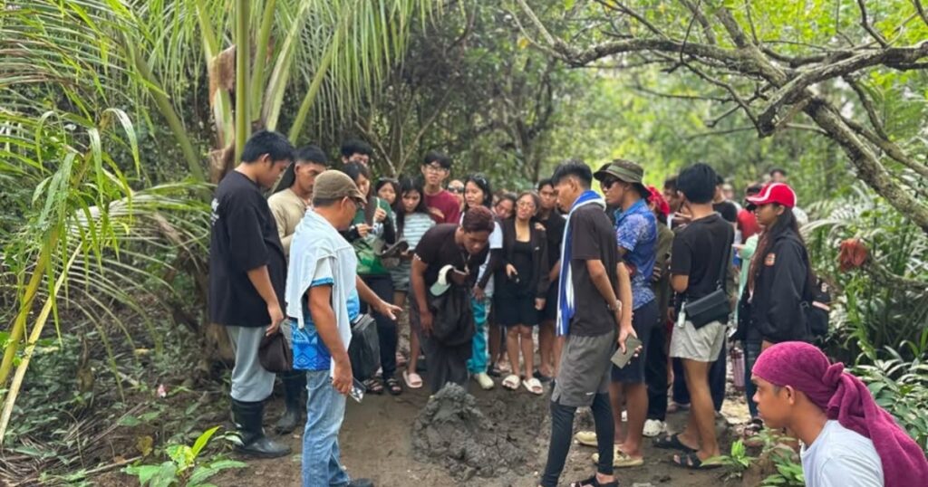 Participants planting mangrove seedlings during Mangrove Camp 2026 in Tagum City.